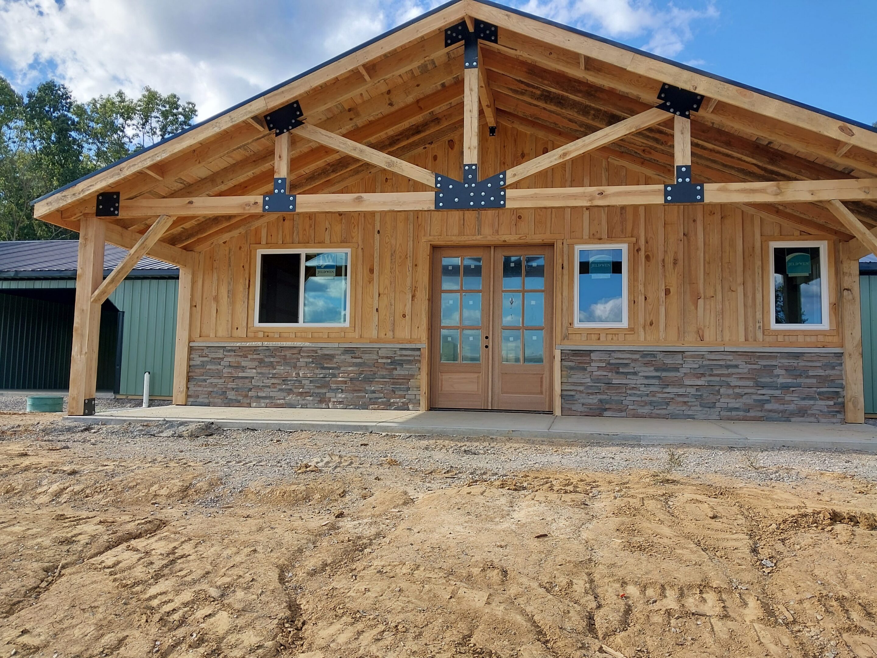 Timber-frame building with stone veneer and porch