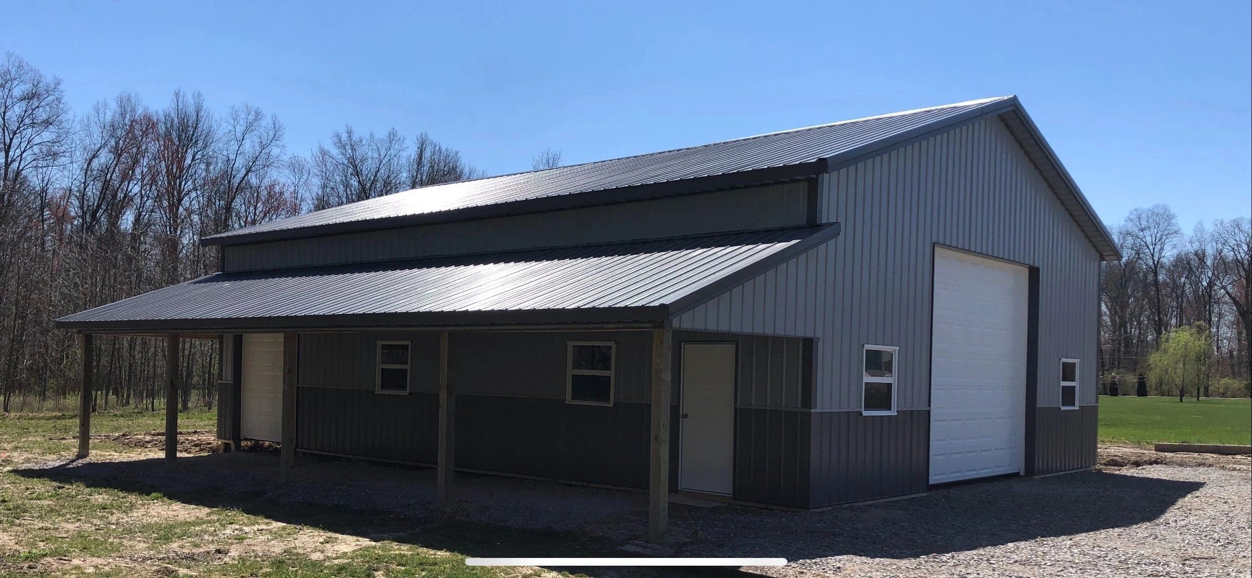 Gray metal barn with large garage door