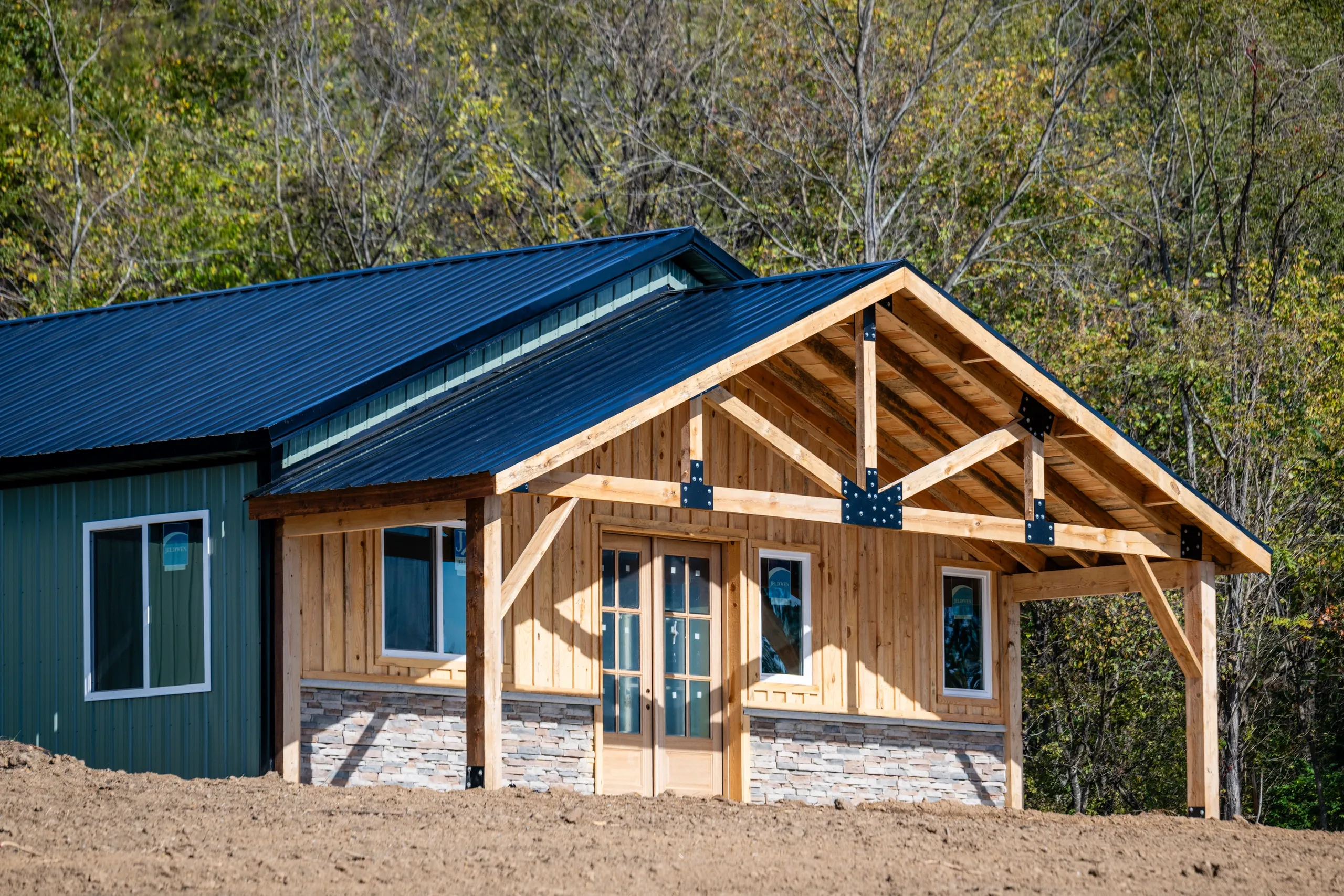 Wooden cabin with covered porch and metal roof