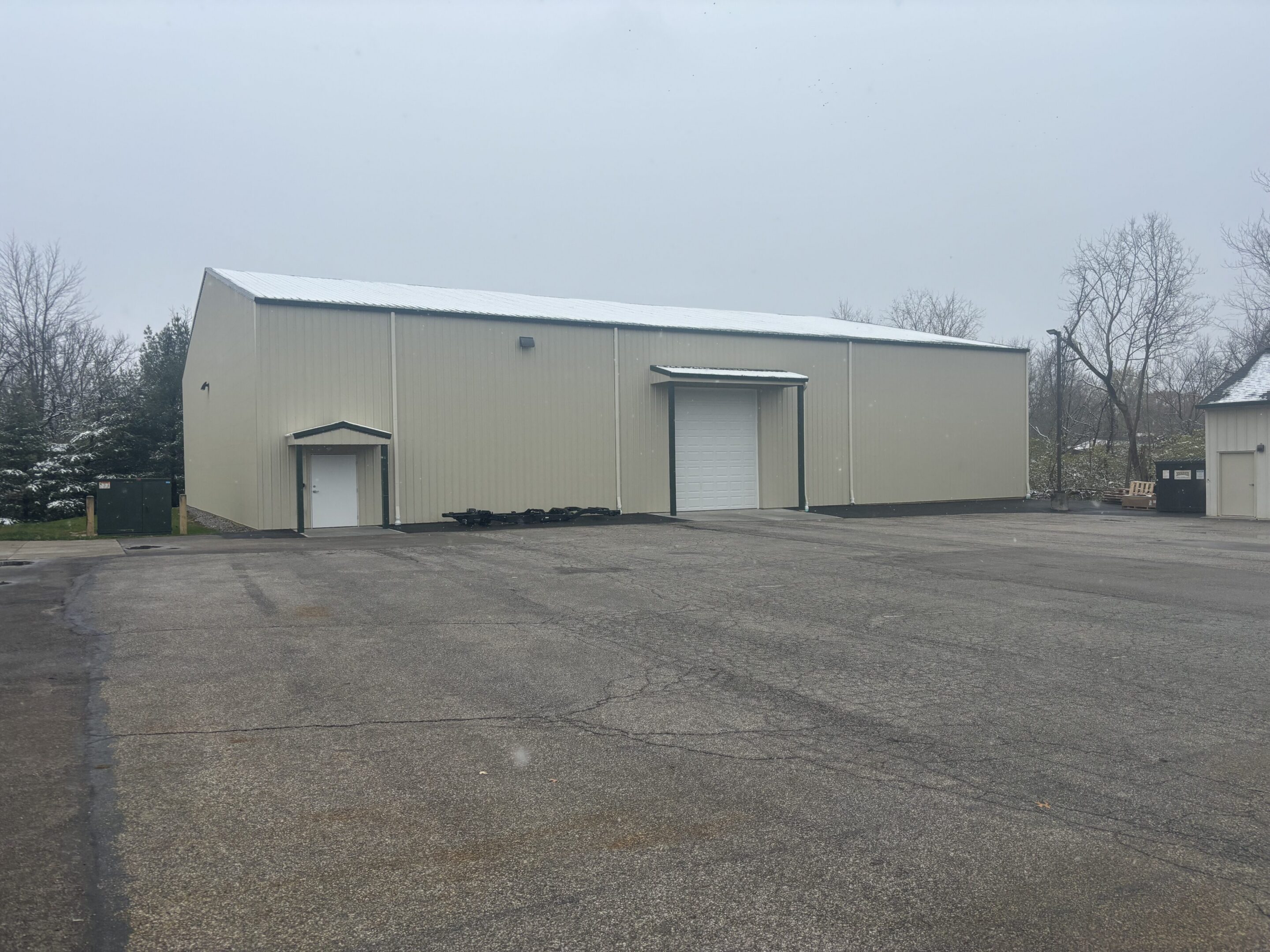 Beige industrial warehouse with roll-up door
