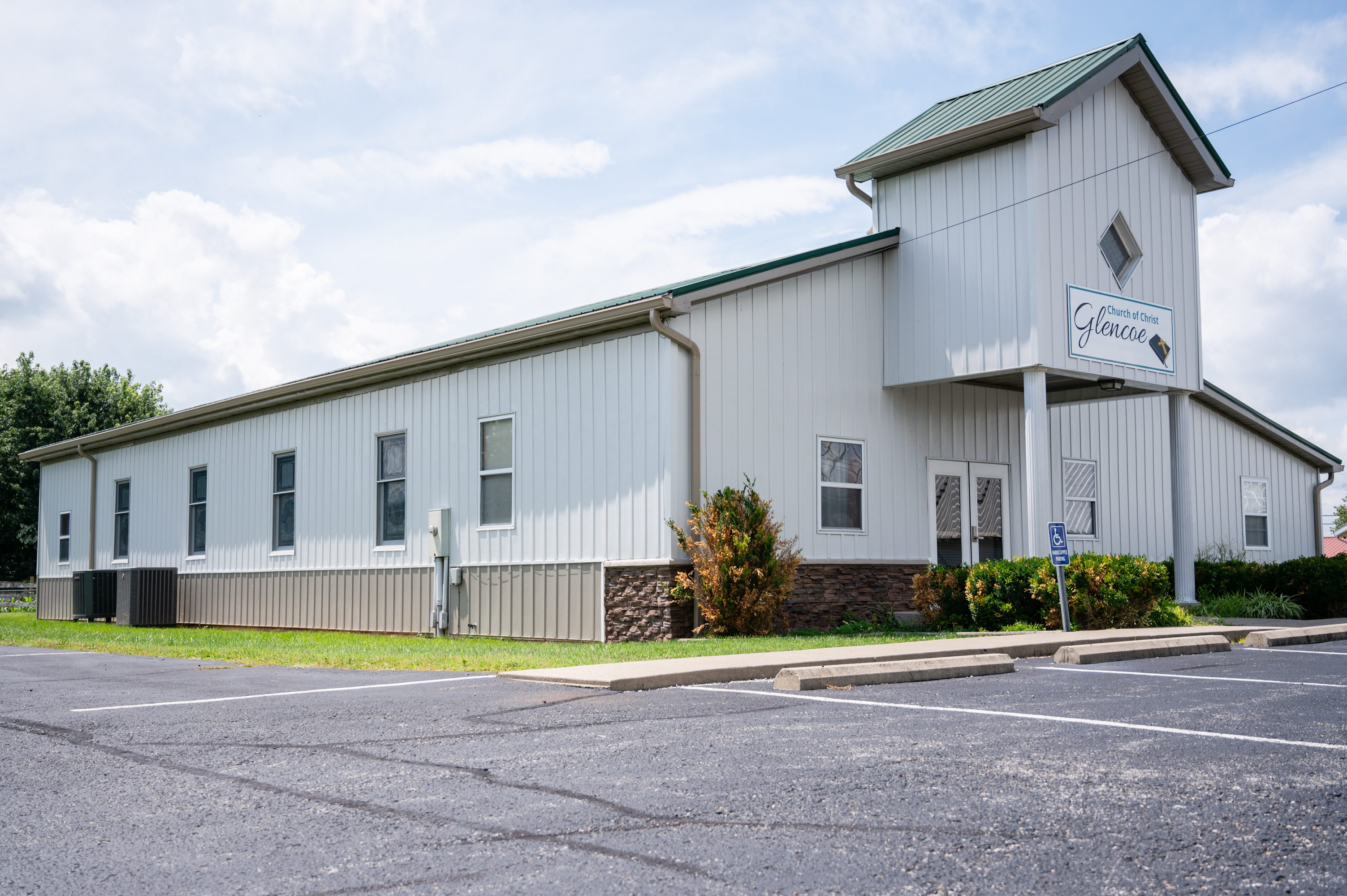 White church building with empty parking lot