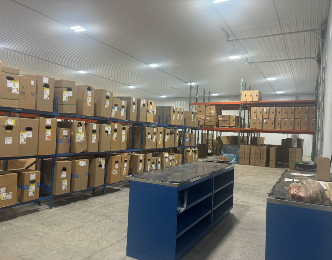 Warehouse aisle with stacked cardboard boxes