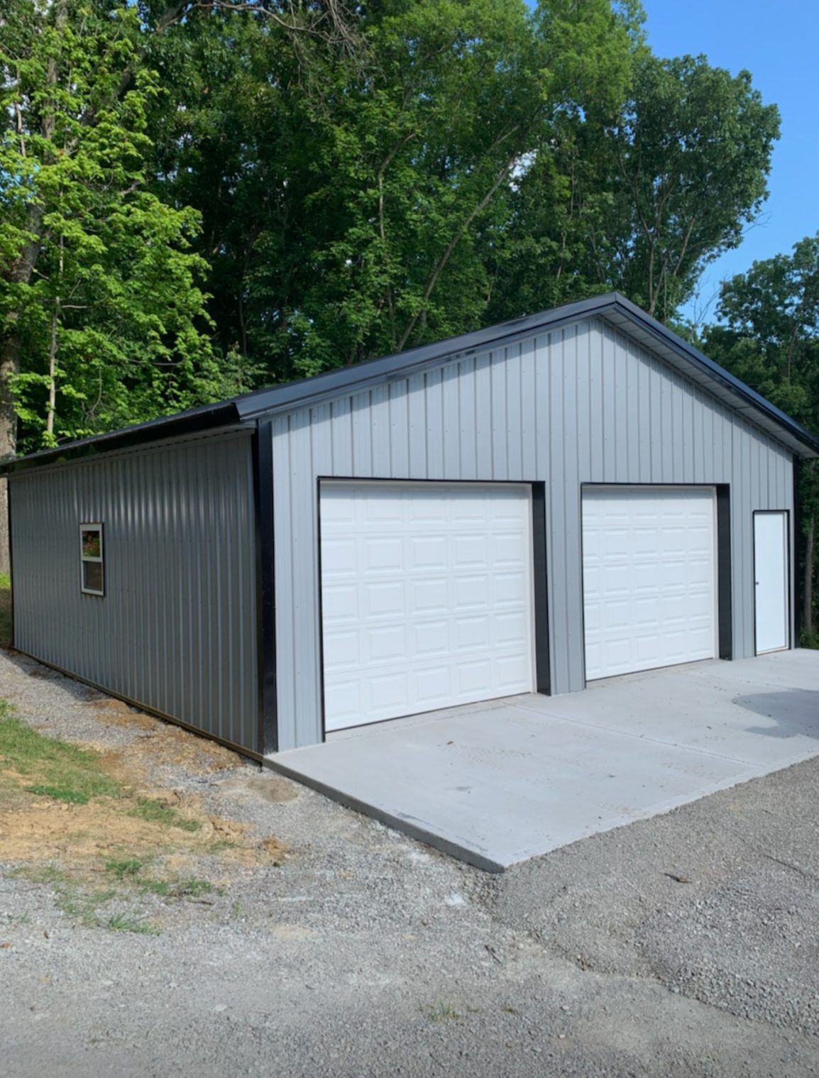 Gray metal garage with two white doors