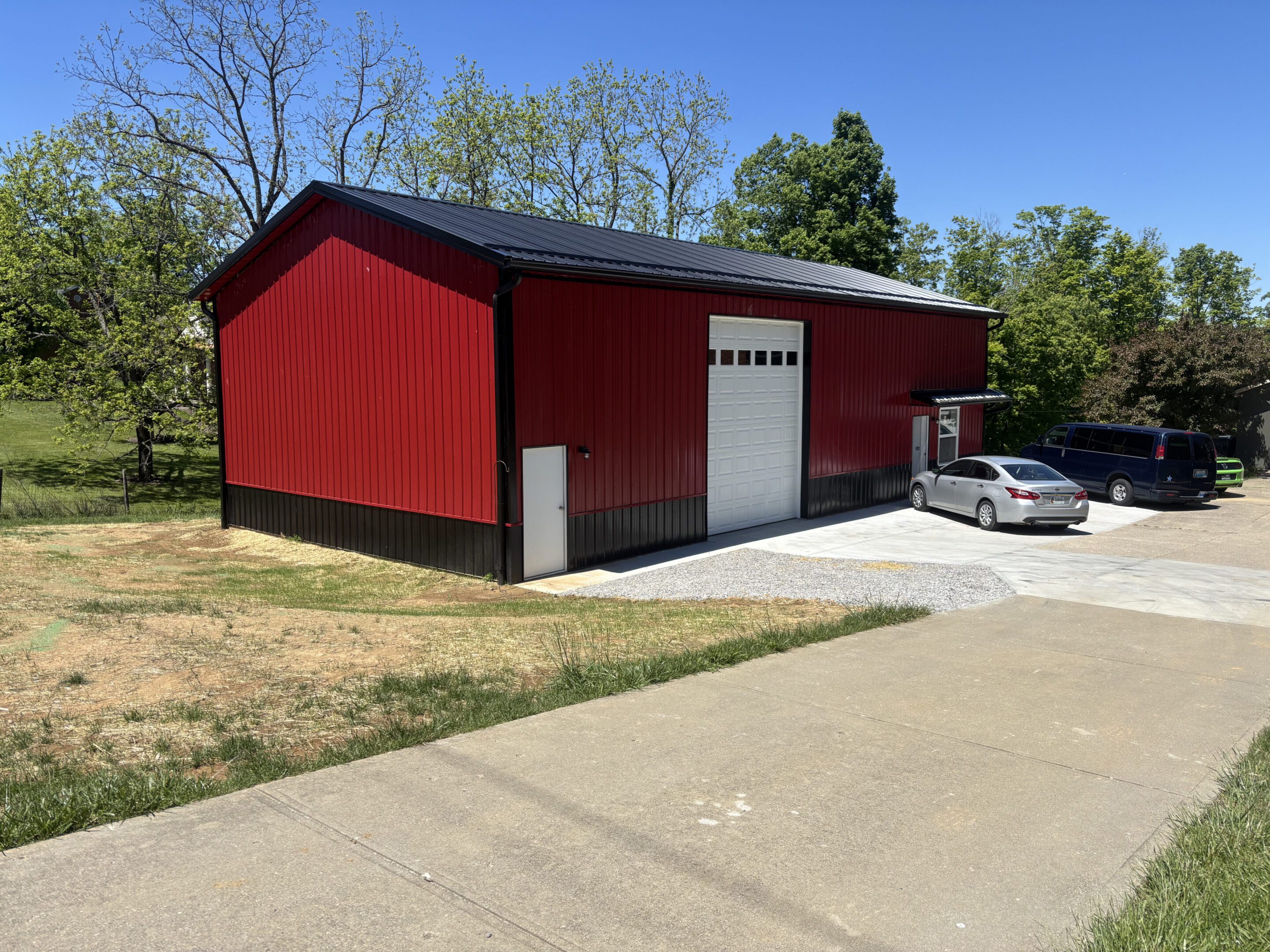 Red metal garage building with parked cars