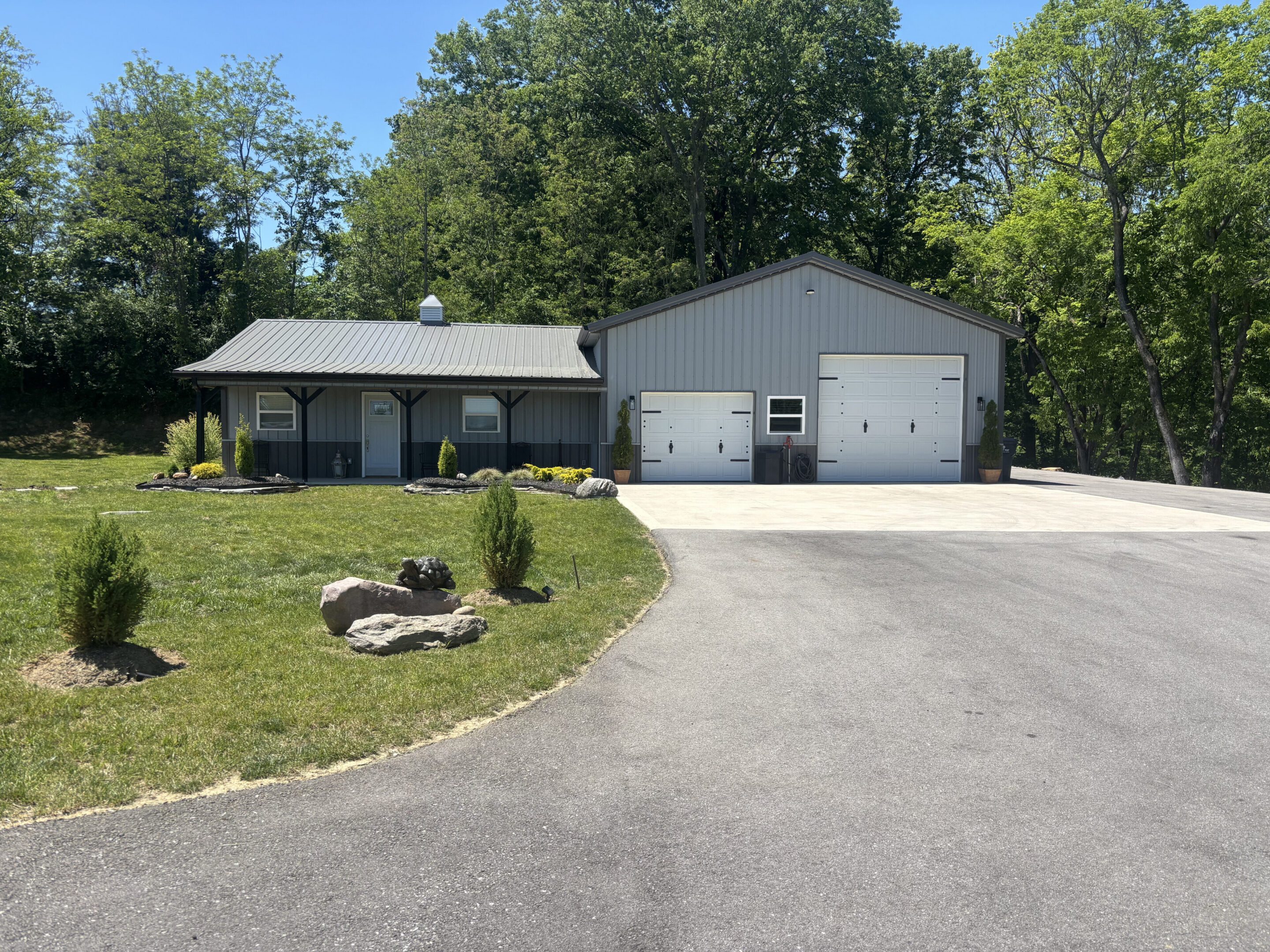 Gray metal building with two garage doors