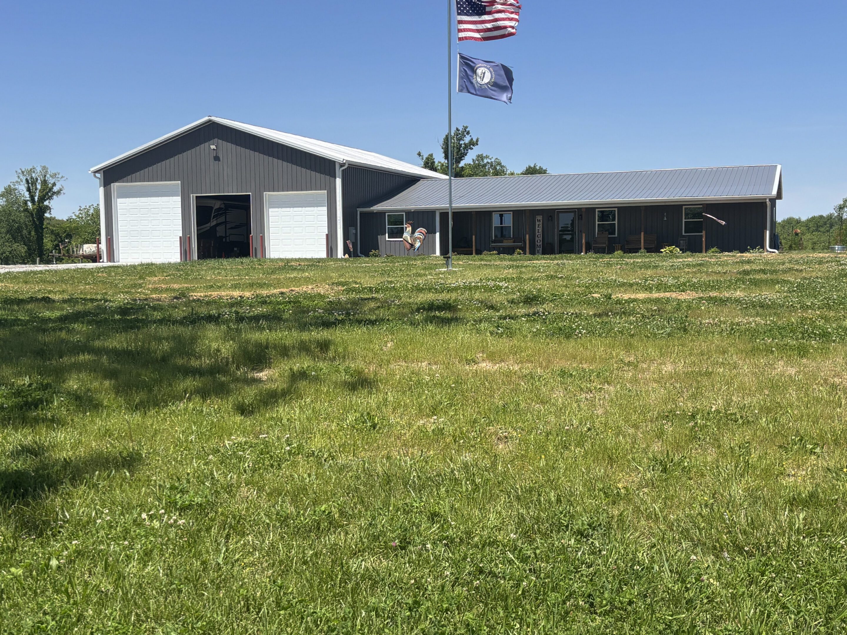Gray metal workshop with American and state flags