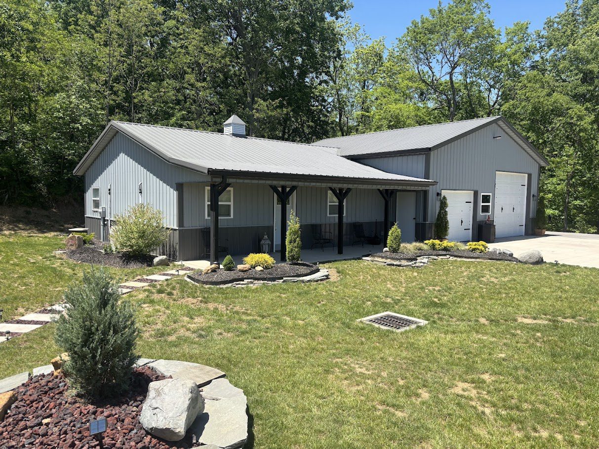 Gray metal workshop with garage and porch