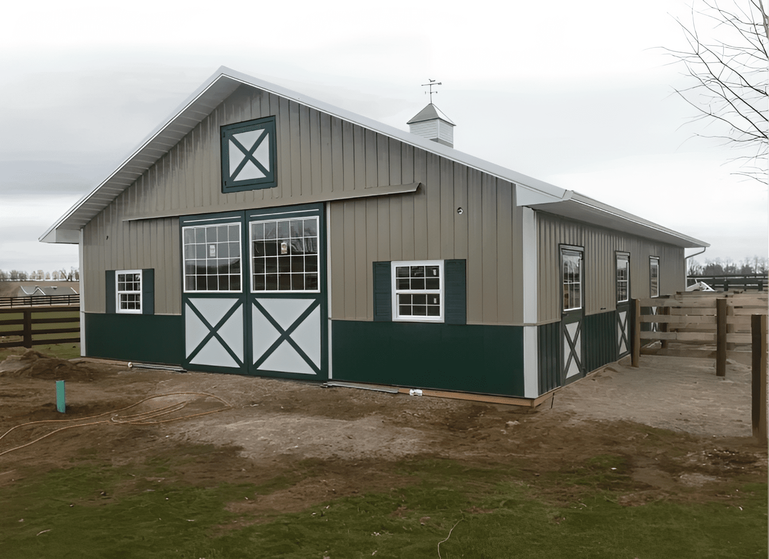 Gray and green metal barn with sliding doors
